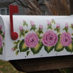 A client comissioned me to paint her mailbox. She wanted roses on it. I came up with this design and she approved it and I painted it on her mailbox.